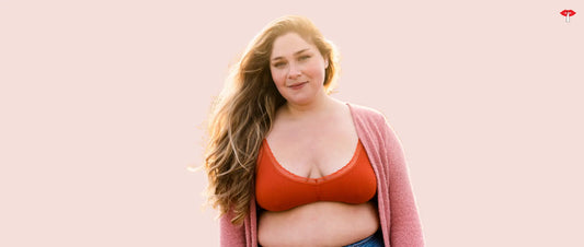 Confident women smiling while wearing a comfortable plus size bra for women against a soft pink background