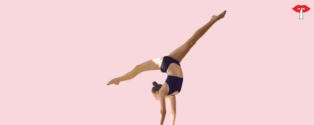 Woman doing a handstand in a black sports bra and shorts - supportive sports bra for women in India by Gossip Store, designed for workout comfort and bust support