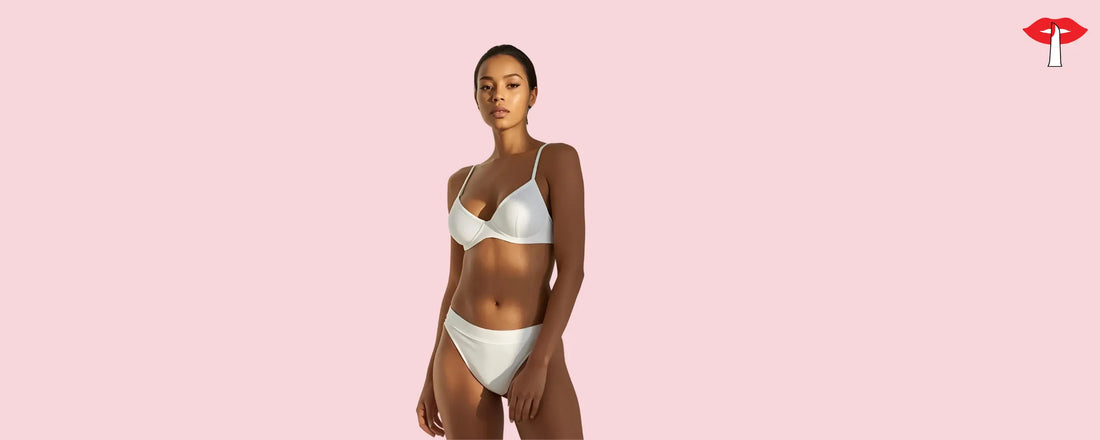 Model wearing a white lingerie set standing against a soft pink wall - Part of Gossip Store's quality lingerie collection