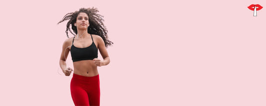 Woman running in a black sports bra and red leggings - supportive activewear lingerie for women in India by Gossip Store, designed for workouts and comfort