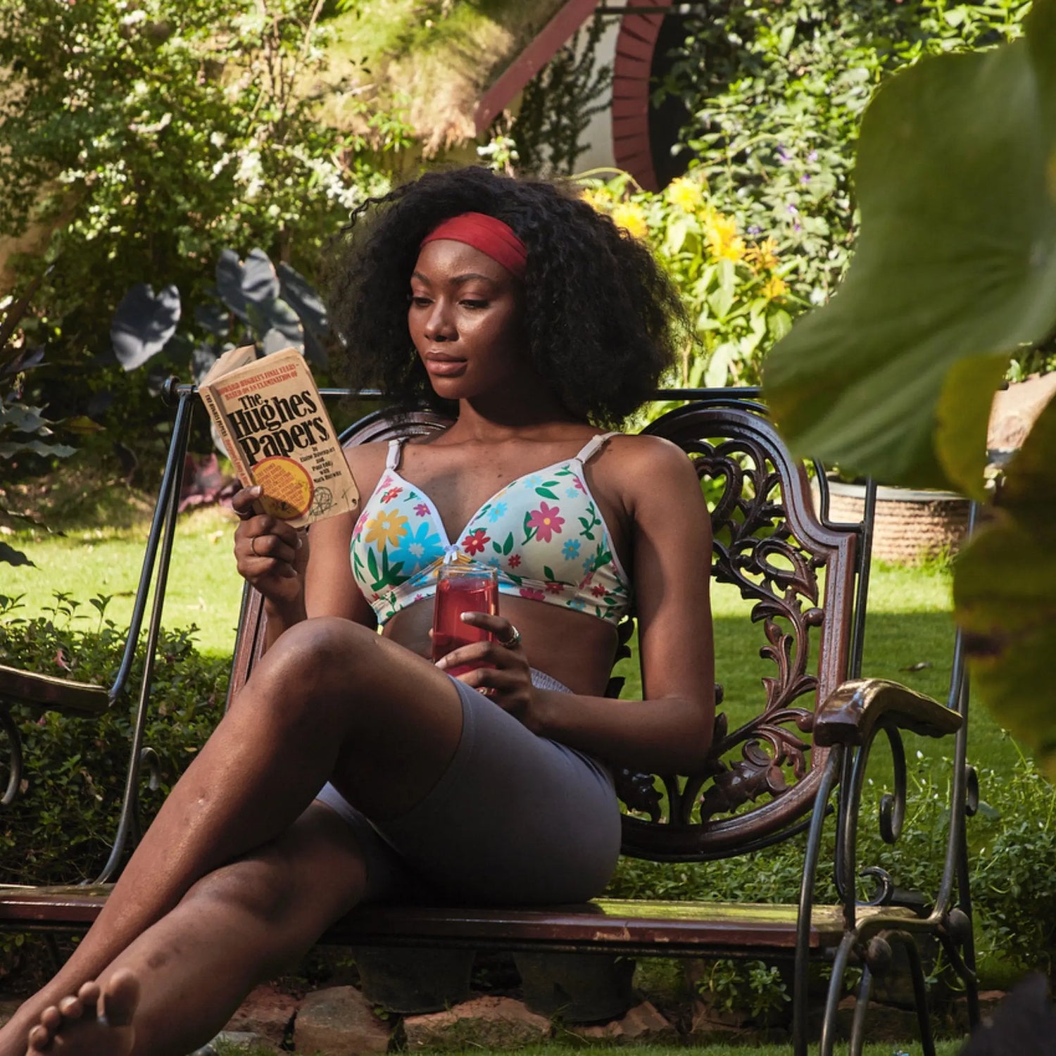 Woman sitting outdoors wearing a printed bra and reading a book, showcasing the comfort and style of the printed bra.