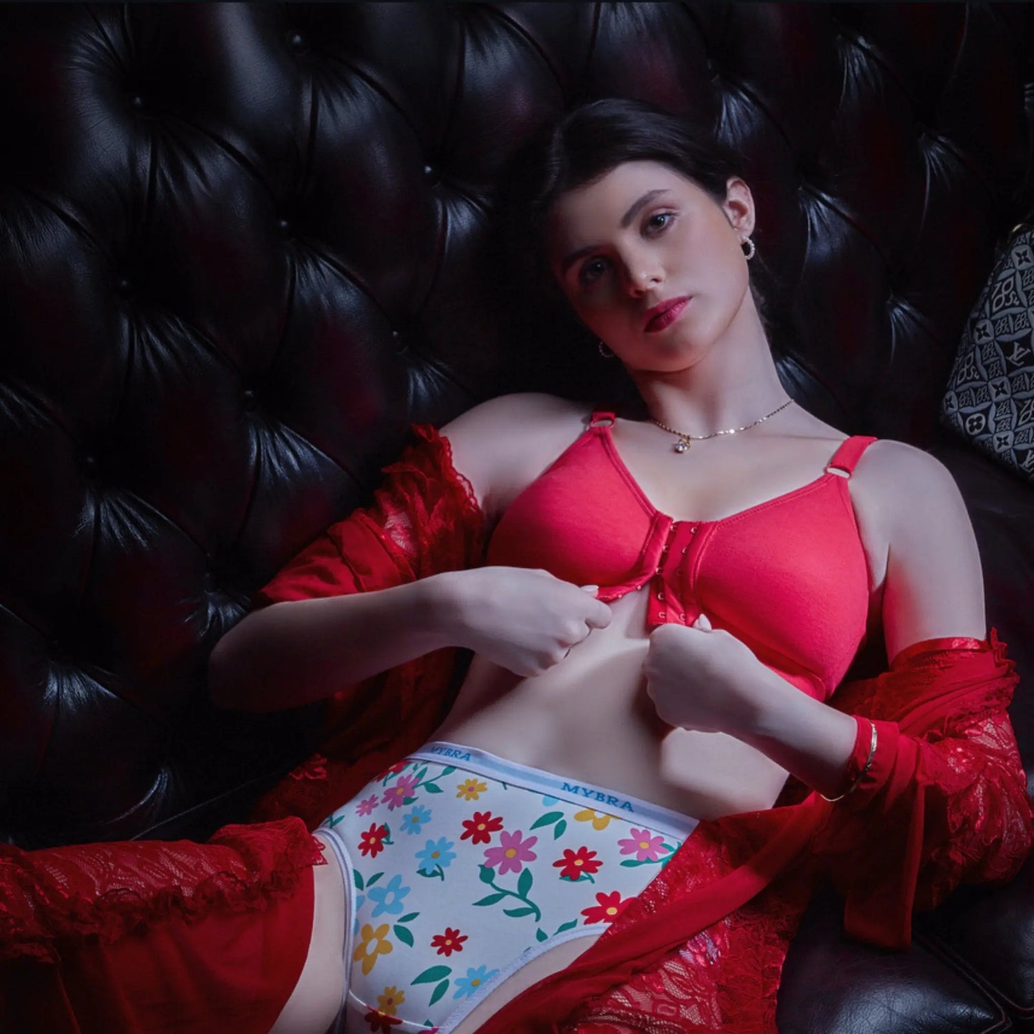 Woman wearing a front open bra and adjusting the front closure, showcasing the convinience and design of the front open bra.